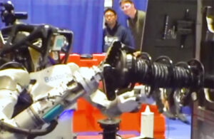 Boston Dynamics' Atlas humanoid picking an automotive strut.
