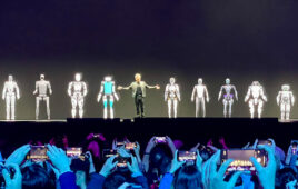 jenson on stage with humanoid robots.